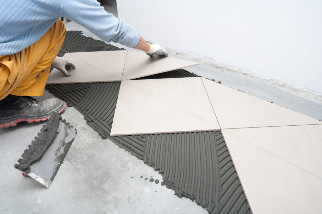 Applying new tiles on bathroom floor